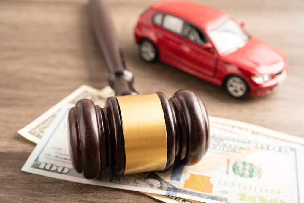 Legal concept of Texas car accident laws with gavel, money, and toy car on wooden table